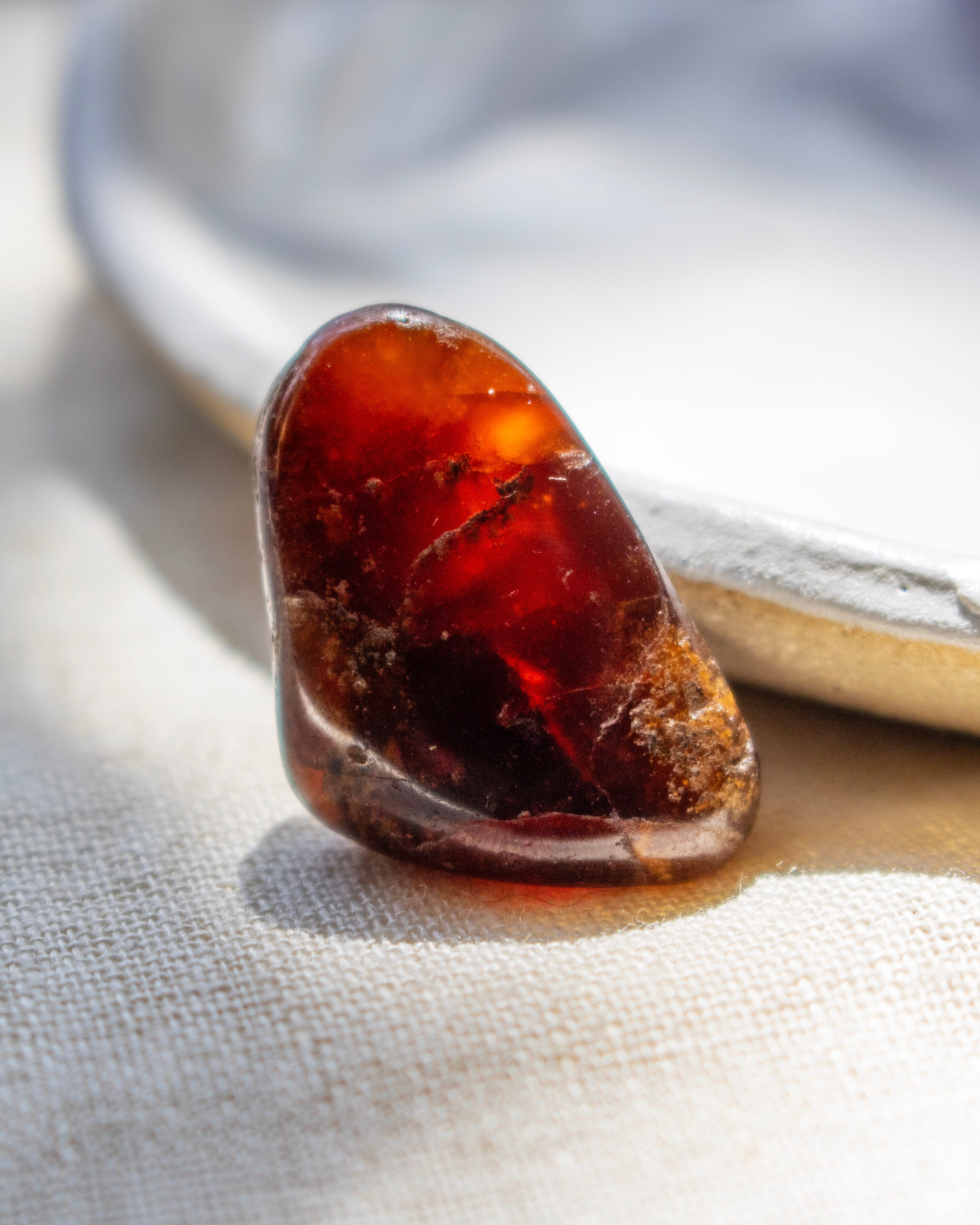 Close-up of a amber stone on a textured fabric background