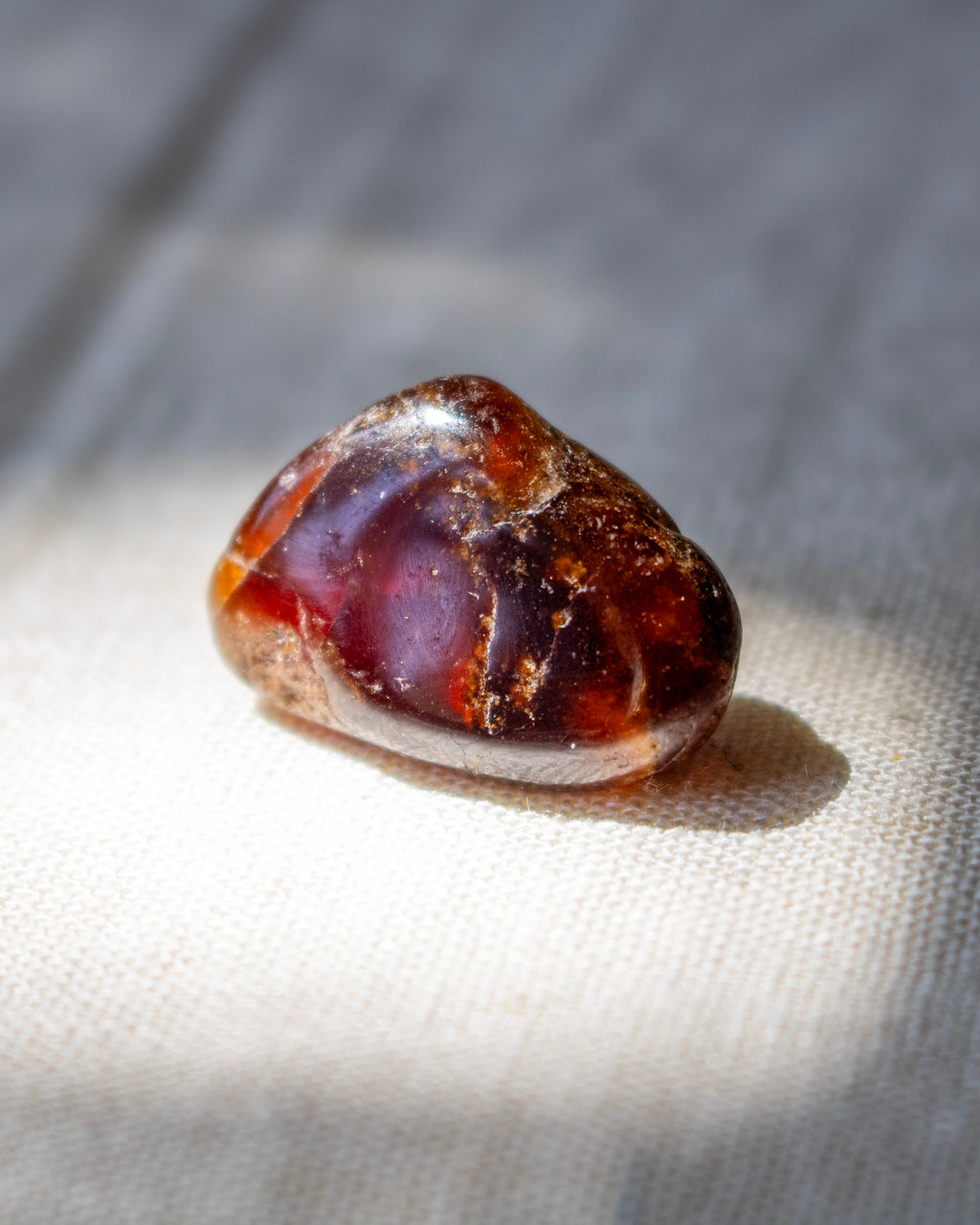 Brown and purple stone on a textured fabric background