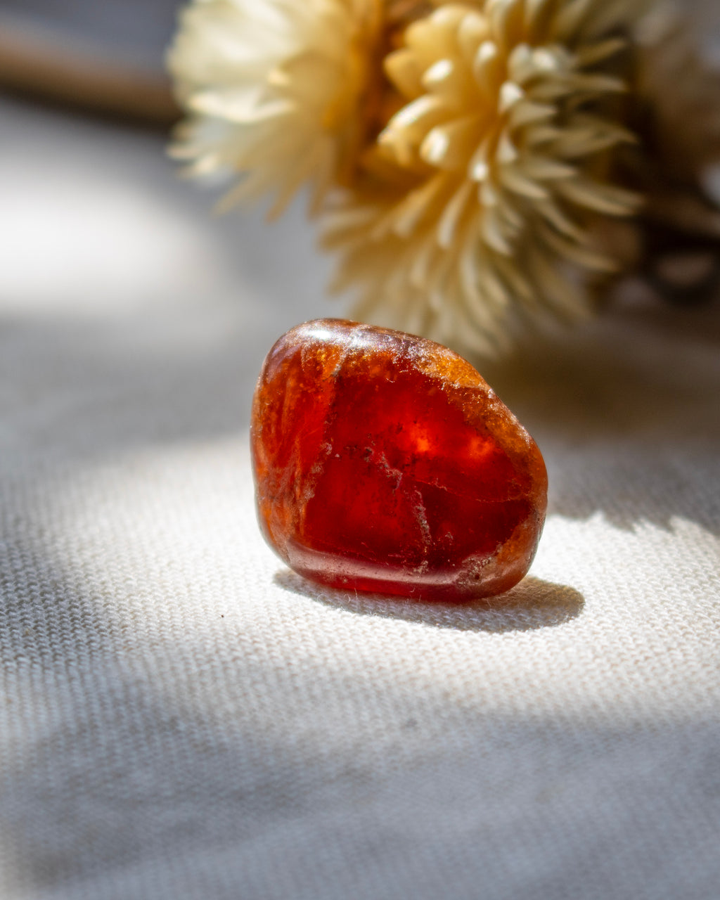 Red stone on a textured surface with a blurred background