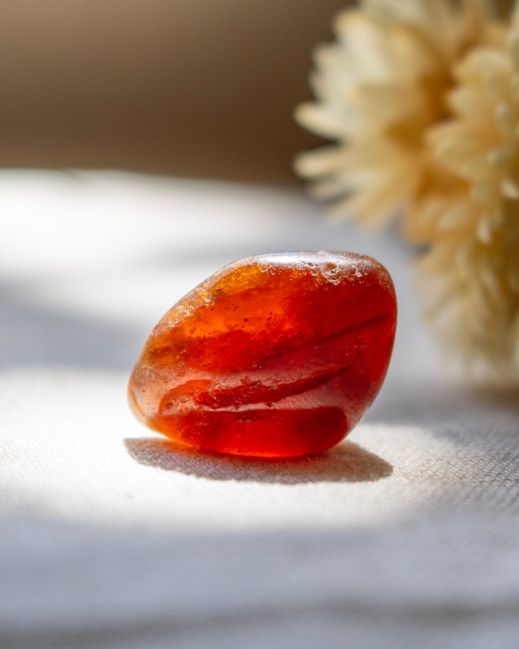 Red stone on a textured surface with a blurred background