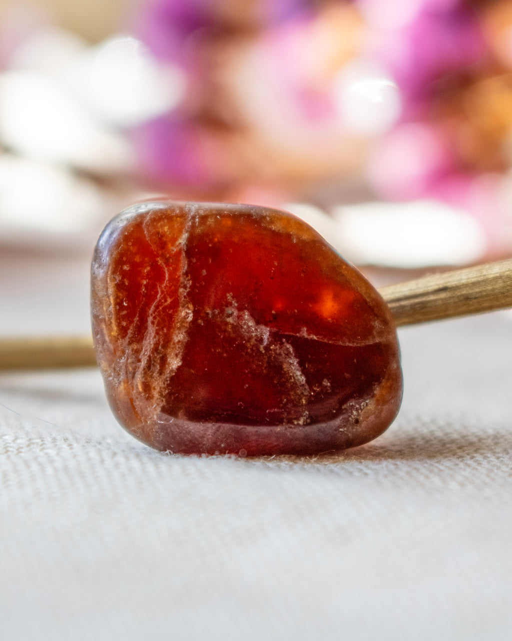 Close-up of a amber stone on a stick with a blurred background