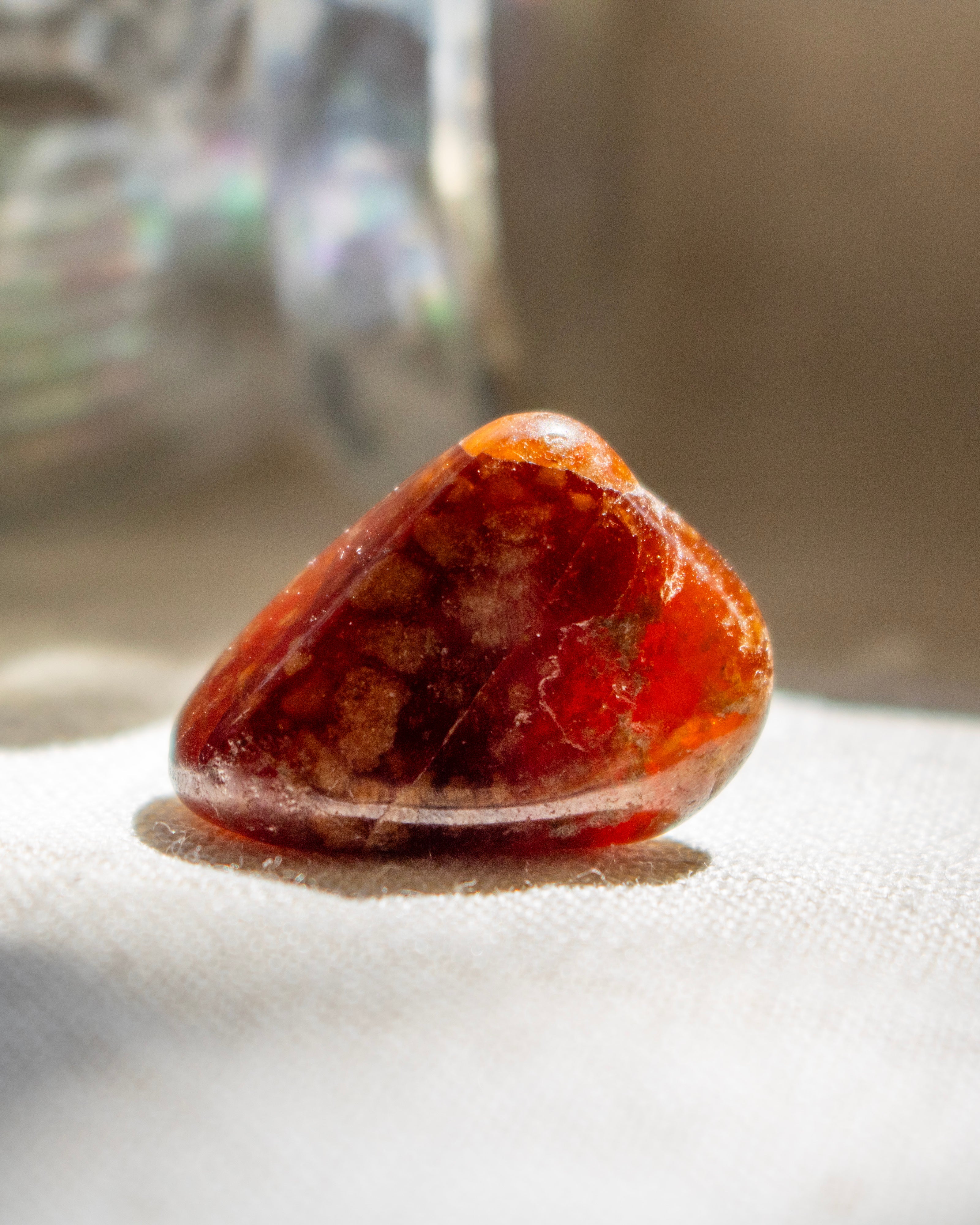 Orange crystal stone on a white fabric background