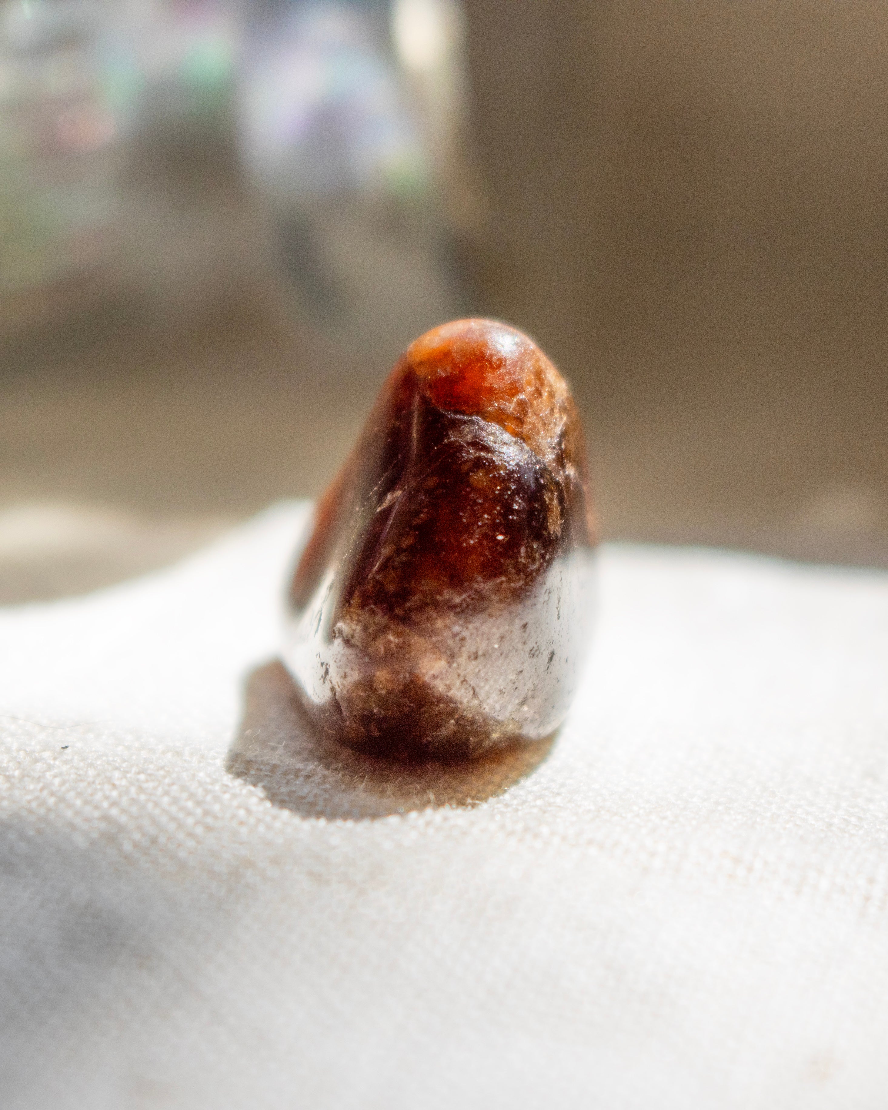 Brown crystal on a white surface with a blurred background