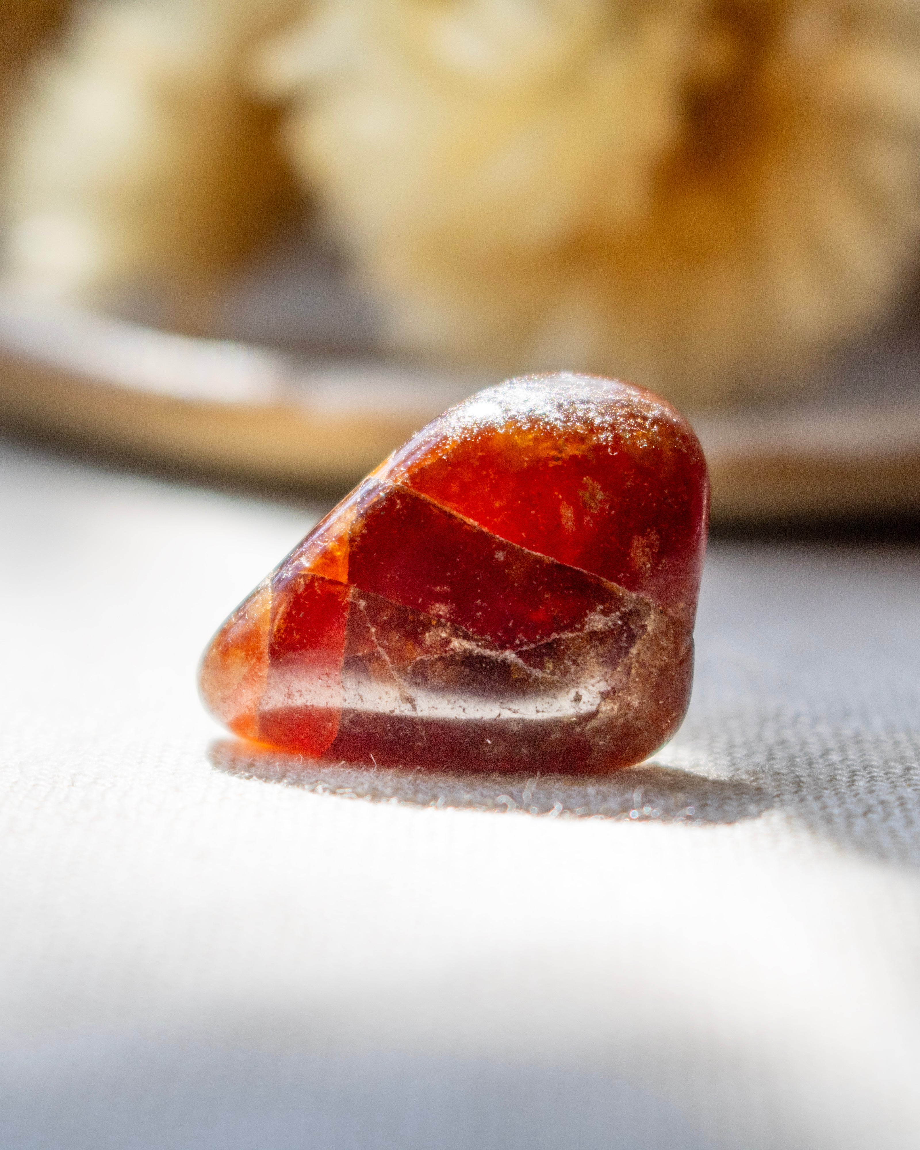 Red stone on a white surface with a blurred background